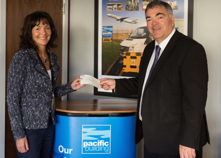 Pacific Building MD Brian Gallacher gives cheque to Nicola Hanssen, of ROAR