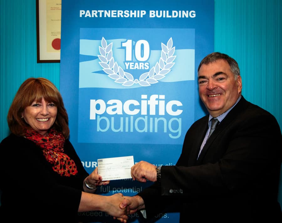 Fiona Scott, head of corporate development at Quarriers, receives a cheque from Pacific Building managing director Brian Gallacher